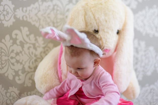 Foto menina sentada com brinquedo de pelúcia em casa