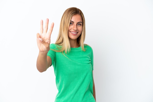 Foto menina uruguaia loira isolada em um fundo branco feliz e contando três com os dedos