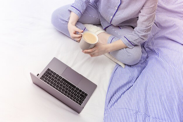 Menina usando laptop e trabalha em casa.