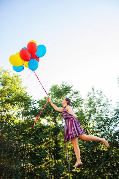 Menina voa com balões. Levitação de balão