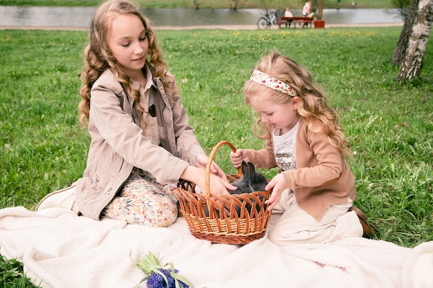 meninas brincando com coelho no parque