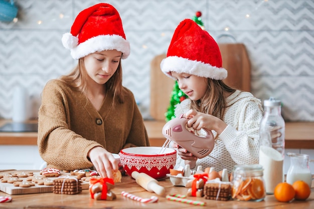 Meninas preparando pão de gengibre de natal em casa