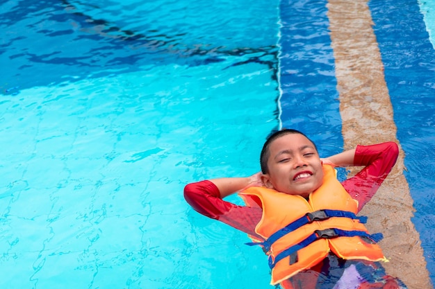 Menino a nadar na piscina