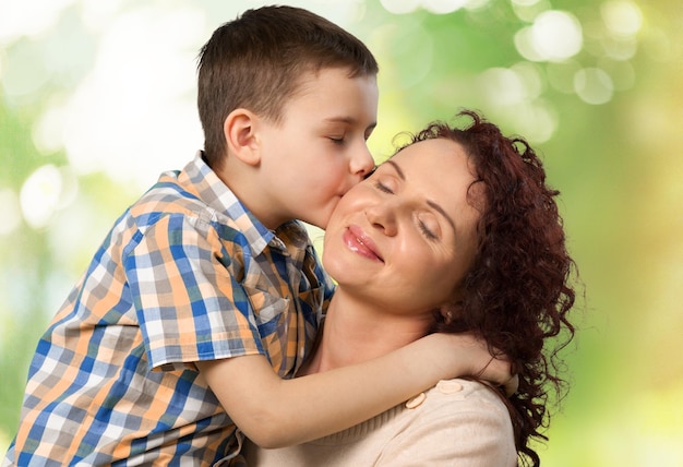 Foto menino bonito criança beijando sua mãe