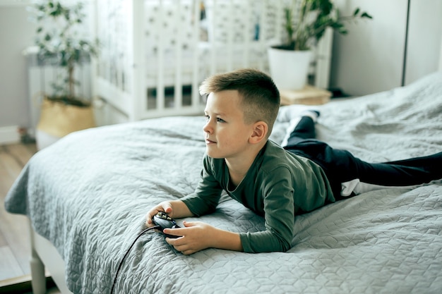 Menino caucasiano jogando videogame. estilo de vida, conceito de lazer.