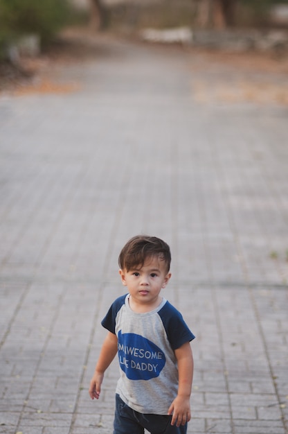 Menino feliz jogando ao ar livre no parque