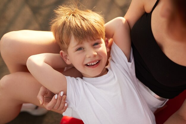 Menino feliz posando com a mãe