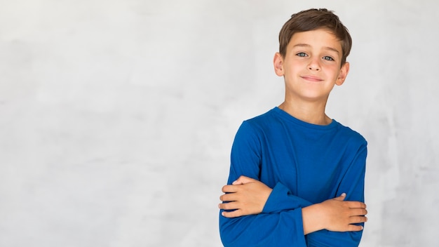 Menino sorridente sendo charmoso com espaço de cópia