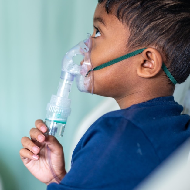 Foto menino usando nebulizador no hospital