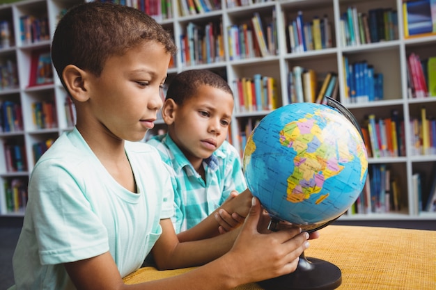 Meninos estudando o globo