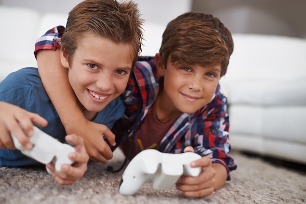 Meninos jogando videogame amigos em retrato e jogos com tecnologia esports e entretenimento na sala de estar Gamer kids jogam no console em casa jovens e crianças do sexo masculino se divertem juntos