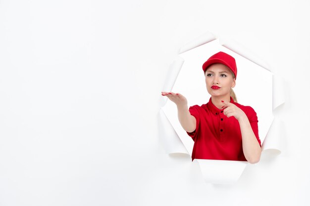 Mensageira com uniforme vermelho apontando para algo em branco