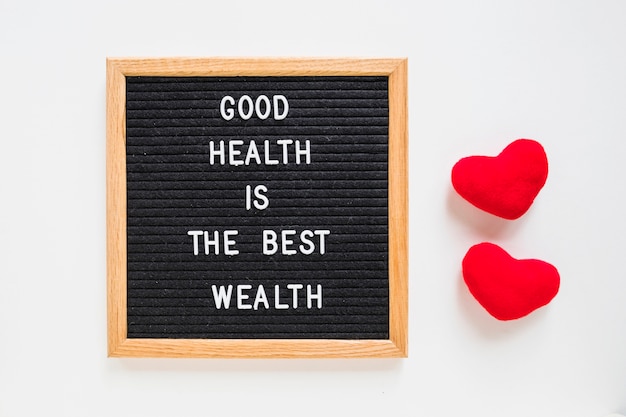 Mensaje de buena salud en tablero negro con corazón rojo relleno