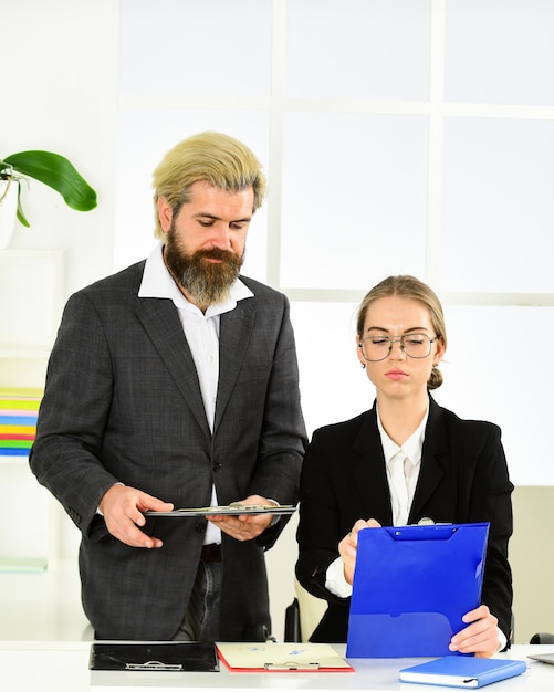 Mentor Coach im Gespräch mit Assistent. Frau und Mann diskutieren Arbeitsfragen. Kollegen Brainstorming im Gespräch Chatten. erklären Ideen am Arbeitsplatz. Geschäftskollegen im modernen Büro. Freude empfinden.