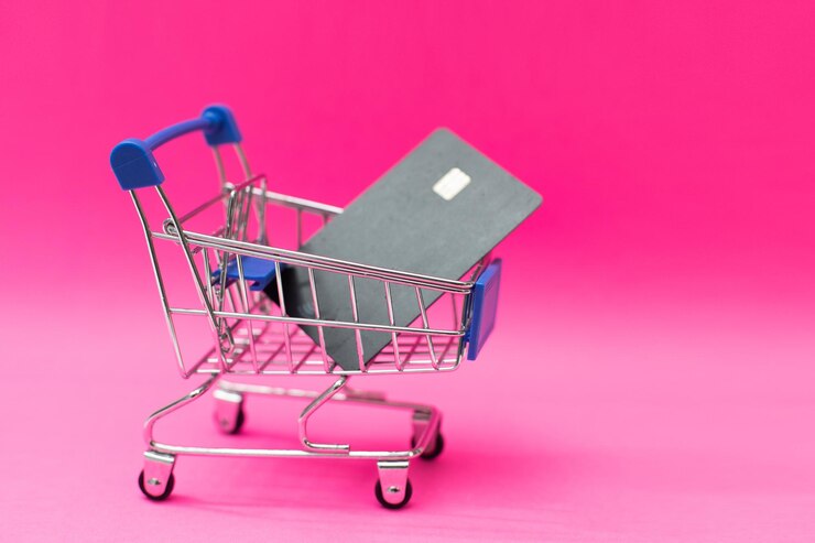 Foto mercado electrónico objetivo. carrito de compras y tarjetas de crédito