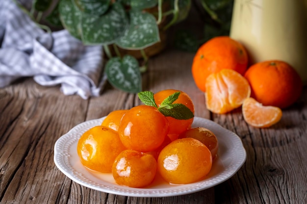 Mermelada de mandarina en tarro de cristal con fruta alrededor