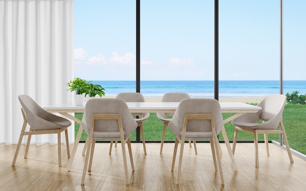 Mesa de comedor en el piso de un gran comedor en una casa moderna o un hotel de lujo con cielo y mar