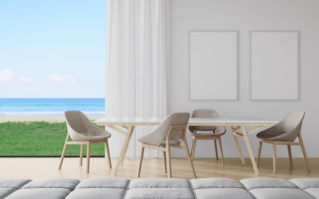 Mesa de comedor con silla y sofá de comedor en casa moderna u hotel de lujo con cielo y mar