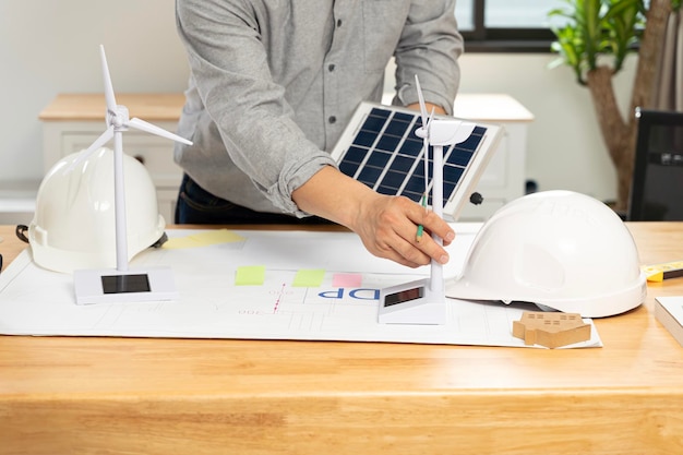 Foto mesa de arquitetos solar energy powered home green para reduzir o conceito de aquecimento global