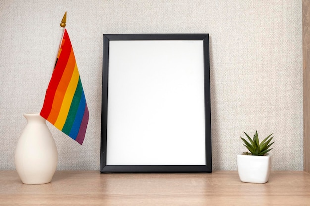 Mesa de escritório lgbt com bandeira do arco-íris e moldura em branco de papelaria com espaço para textx9