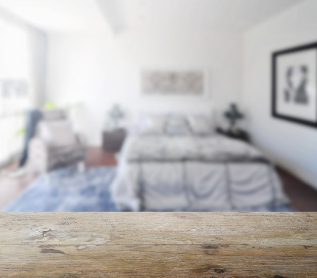 Foto mesa de madeira com borrão de interior moderno quarto como pano de fundo