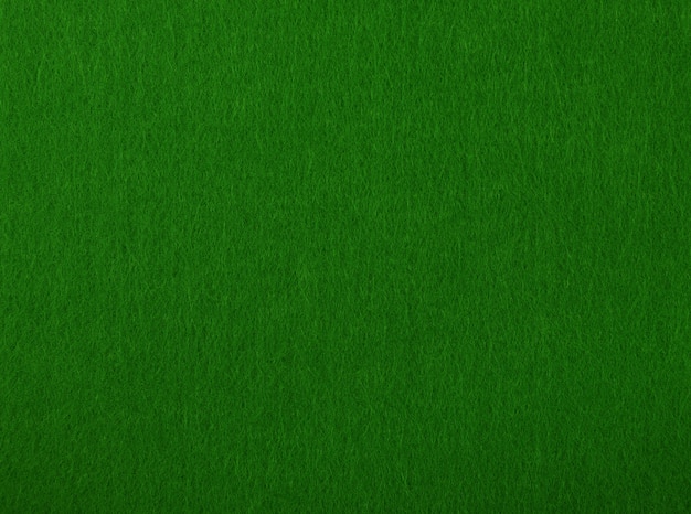 Foto mesa de pôquer verde escuro com textura de fundo de material têxtil áspero macio, close-up