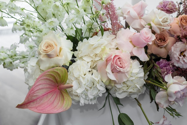 Mesa de restaurante branco evento servida e decorada com delicadas flores frescas