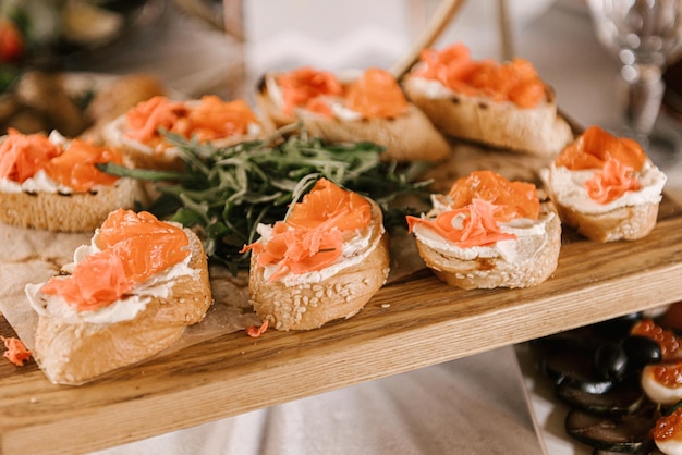 Mesa festiva con comida buffet bruschettas con requesón y pescado rojo