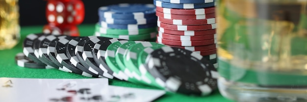 En la mesa hay fichas para cartas de casino y vaso de alcohol concepto de adicción al juego