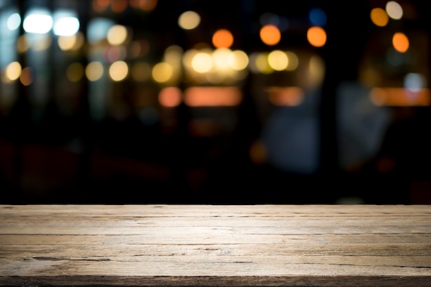 Mesa de madera vacía plataforma y bokeh en la noche