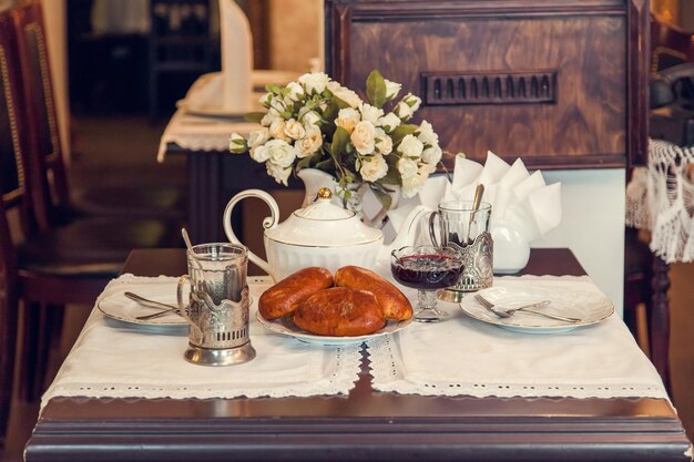 Una mesa puesta para beber té al estilo retro de los tiempos de la URSS con pasteles horneados