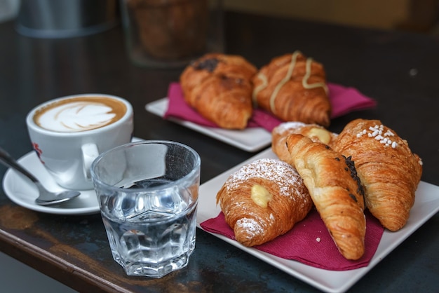 Una mesa con una taza de café y pasteles.