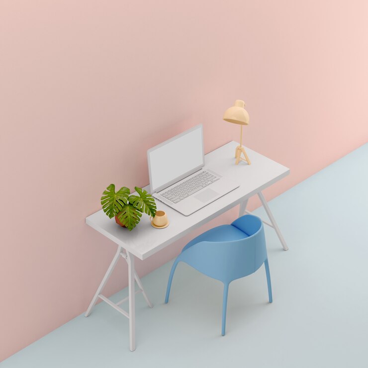 Mesa de trabajo con ordenador portátil contra la pared colorida