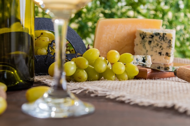 Foto mesa de vino con queso y uvas.