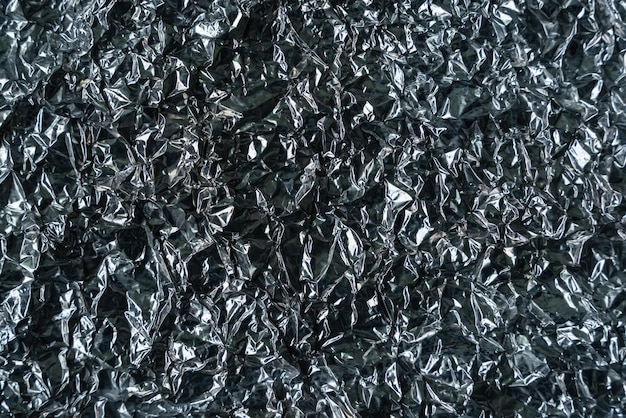 Foto metallisches papier mit abstrakten texturmustern, das als hintergrund oder tapete verwendet wird metallaluminiumfolie glänzend und reflektor