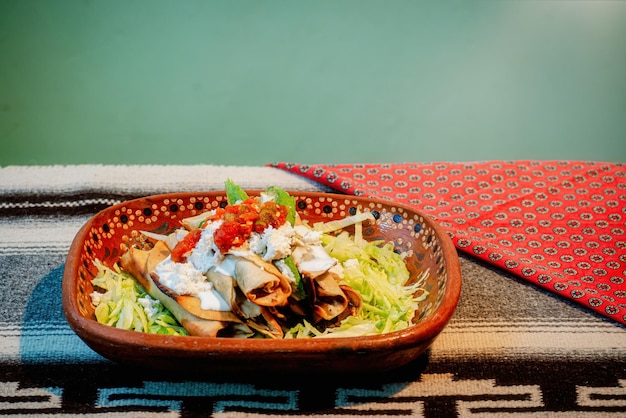 Mexikanische Flautas mit Salat-Avocado-Sahnesauce und frischem Wasser