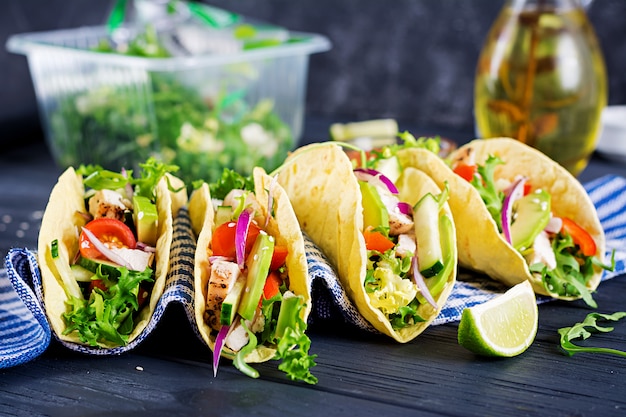 Mexikanische Tacos mit Hühnerfleisch, Avocado, Tomate, Gurke und roter Zwiebel. Gesunde Tortilla. Wrap Essen. Taco