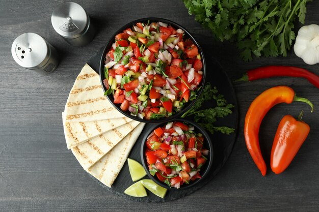 Mexikanisches Essenskonzept mit Pico de Gallo auf dunklem Holztisch