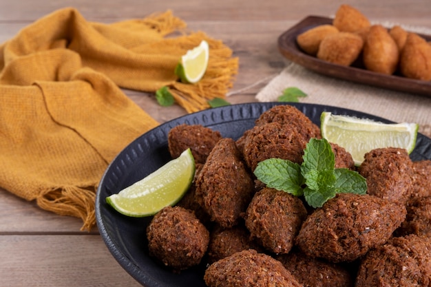 Mezcla de bocadillos salados fritos brasileños con coxinha y kibbeh frito.