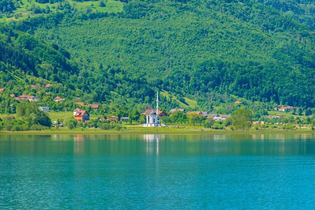 La mezquita blanca se encuentra en la orilla de un lago de montaña