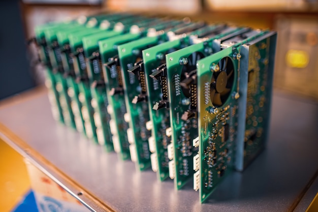 Los microcircuitos integrados verdes de primer plano se apilan en una caja para prepararse para el futuro en la fábrica para la producción de equipos