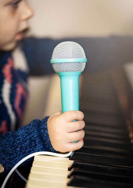 Microfone da criança da menina, do piano e do brinquedo.