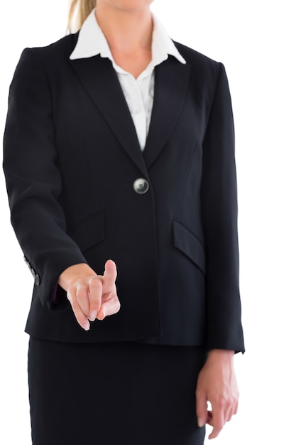 Mid section of blonde businesswoman pointing to camera