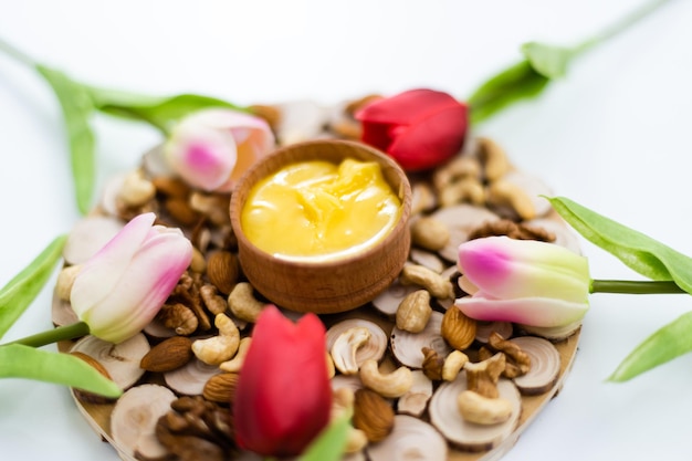 miel en un cuenco de madera y flores tulipanes, día de la mujer, concepto matutino.