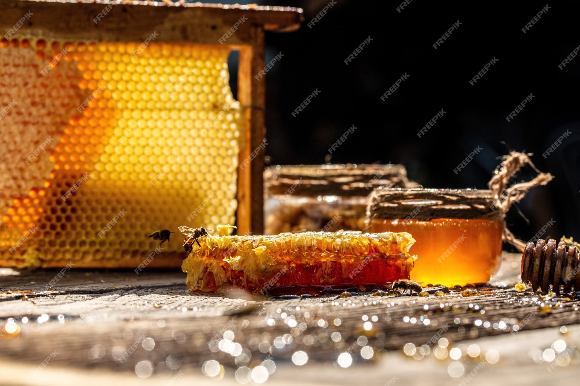 Miel recipiente de vidrio, cucharón de miel de y panales con miel en mesa de | Foto Premium