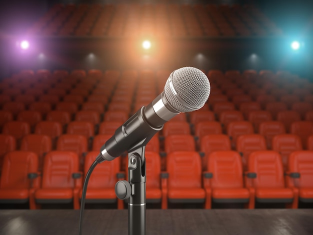 Mikrofon auf der Bühne eines Konzertsaals oder Theaters mit roten Sitzen und Scheinwerferlicht