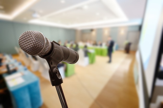 Mikrofon über dem unscharfen Geschäftsforum Sitzung oder Konferenztraining, die Trainierraum-Konzept, unscharfen Hintergrund lernen.