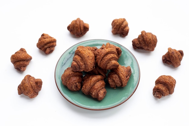 Mini croissant de chocolate sobre fondo blanco.