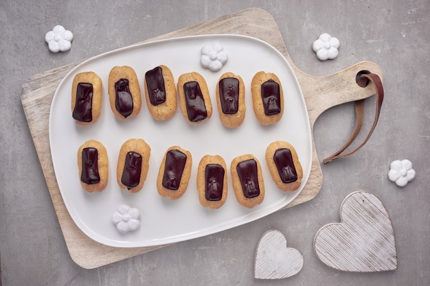 Mini eclairs de baunilha com cobertura de chocolate, vista superior