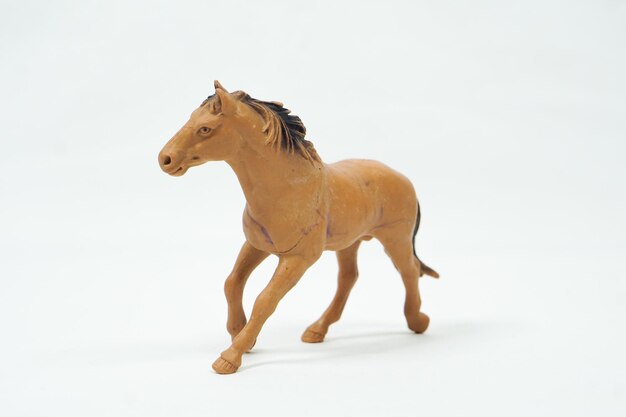 Foto mini figura de caballo aislada sobre fondo blanco. juguetes de animales de plástico.